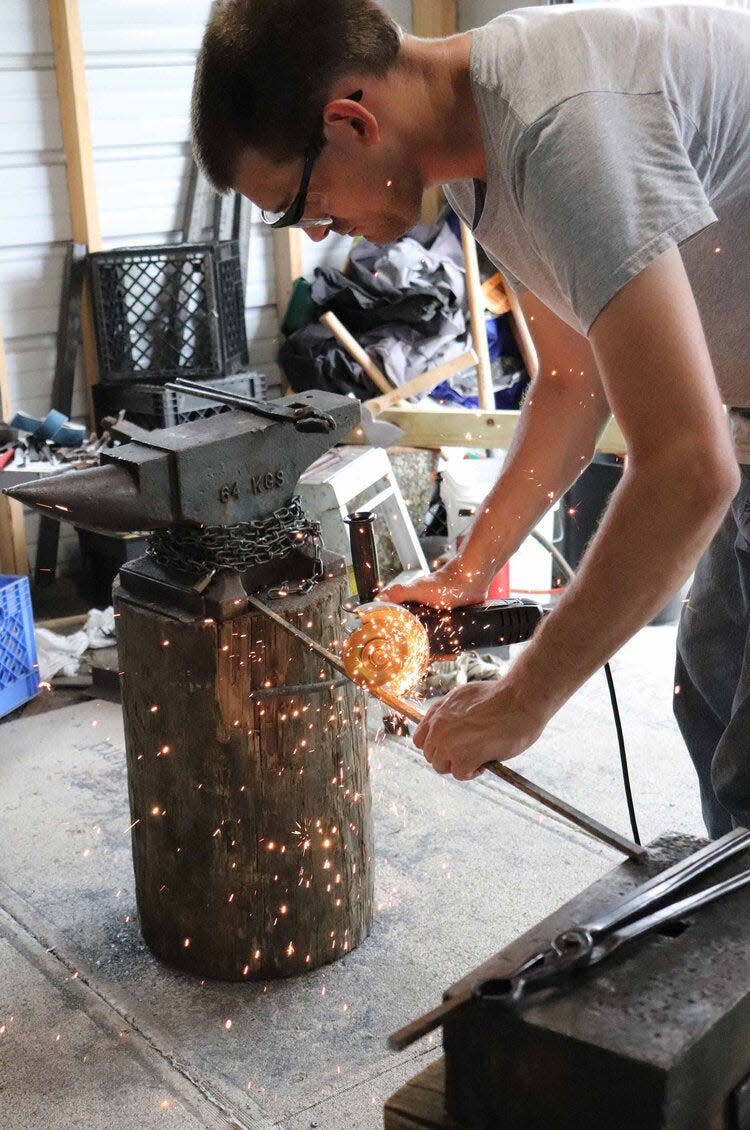 Gulf Coast Blacksmith Association president Jared Kattengell of New Orleans works in his shop, heating and hammering metal.