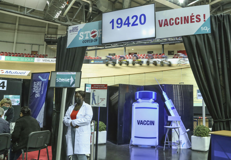 Riders train at the National Velodrome at Saint-Quentin-en-Yvelines, west of Paris, Saturday, March 27, 2021, that has been transformed into a mass vaccination center. Saturday marked the first day in France of vaccination for healthy people aged 70 and above. (AP Photo/John Leicester)