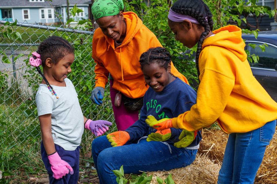 During their first day in their urban garden, Tysha Ahmad and some of her campers admire an earth worm Tuesday, June 13, 2023. Part of the first week of camp is coming up with camper rules and goals.