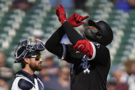 Chicago White Sox's Eloy Jimenez, right, celebrates his two-run home run as Detroit Tigers catcher Eric Haase looks on in the seventh inning of a baseball game in Detroit, Monday, Sept. 27, 2021. (AP Photo/Paul Sancya)