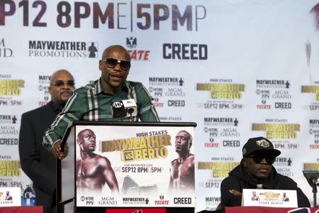 Undefeated WBC/WBA welterweight champion Floyd Mayweather Jr. speaks as challenger Andre Berto (R) listens during a news conference at MGM Grand Hotel & Casino in Las Vegas September 9, 2015. REUTERS/Las VegasSun/Steve Marcus