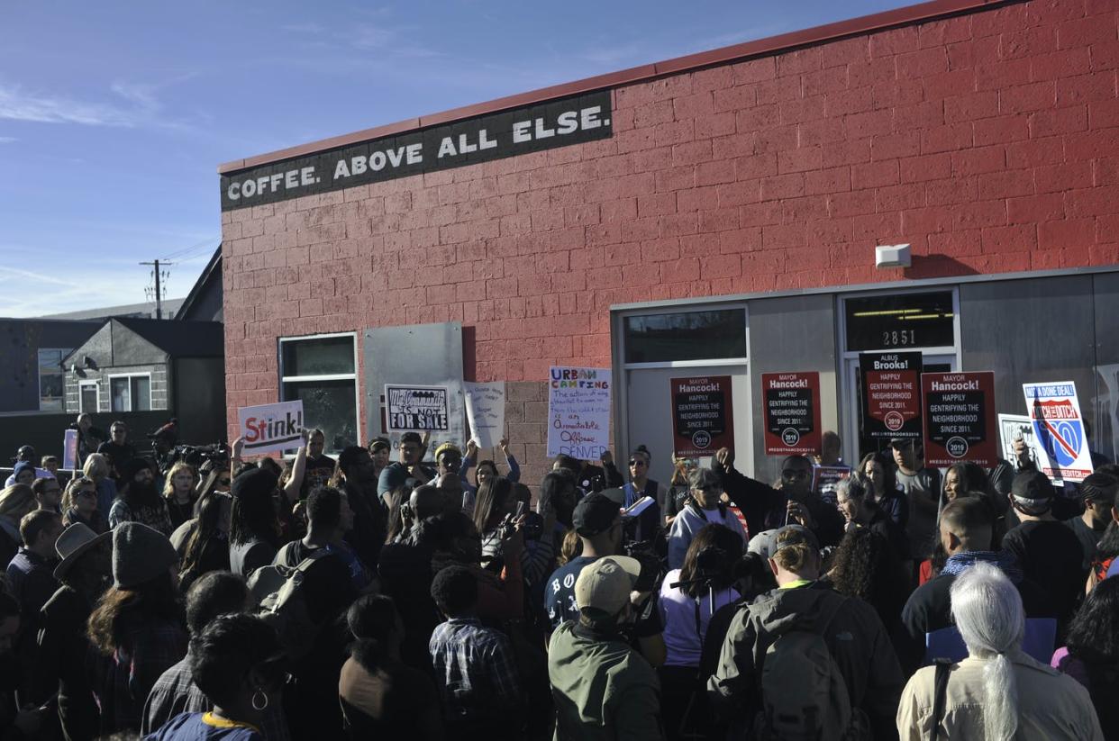 <span class="caption">Residents of Denver's Five Points neighborhood protest in 2017 outside a coffee shop that posted a sign celebrating gentrification.</span> <span class="attribution"><a class="link " href="https://www.gettyimages.com/photos/denver-gentrification?family=editorial&groupbyevent=true&phrase=Denver,%20gentrification,&sort=best#license" rel="nofollow noopener" target="_blank" data-ylk="slk:Patrick Traylor/The Denver Post via Getty Images;elm:context_link;itc:0;sec:content-canvas">Patrick Traylor/The Denver Post via Getty Images</a></span>