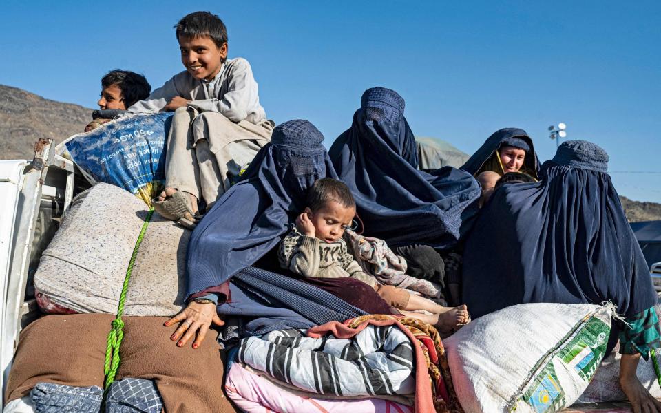 Afghan women and their children on a truck to Jalalabad from a makeshift camp near the Afghanistan-Pakistan Torkham border