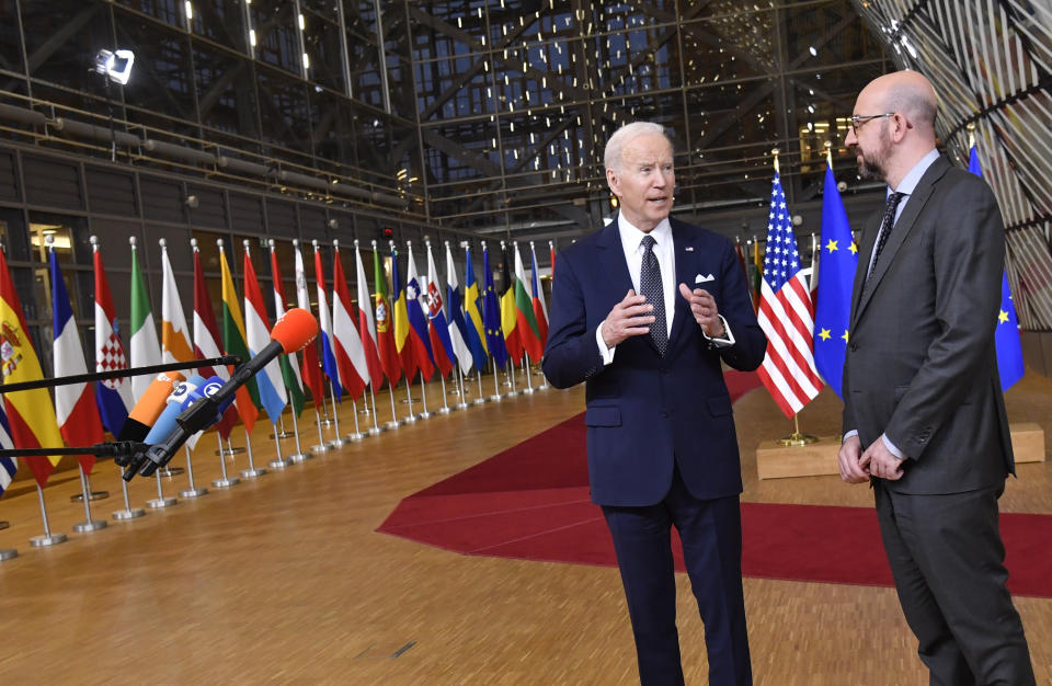 U.S. President Joe Biden, left, speaks with the media as he stands with European Council President Charles Michel during arrival for an EU summit at the European Council building in Brussels, Thursday, March 24, 2022. As the war in Ukraine grinds into a second month, President Joe Biden and Western allies are gathering to chart a path to ramp up pressure on Russian President Vladimir Putin while tending to the economic and security fallout that's spreading across Europe and the world. (AP Photo/Geert Vanden Wijngaert)