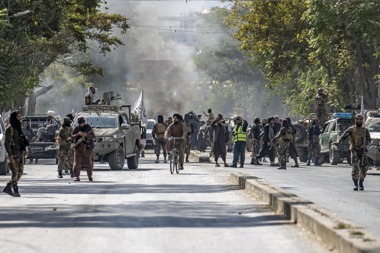 Taliban fighters stand guard at the explosion site, near a mosque, in Kabul, Afghanistan, Friday, Sept. 23, 2022. An explosion went off near a mosque in Afghanistan's capital of Kabul on Friday, with police confirming casualties. A column of black smoke rose into the sky and shots rang out several minutes after the blast in the city's diplomatic quarter. (AP Photo/Ebrahim Noroozi)