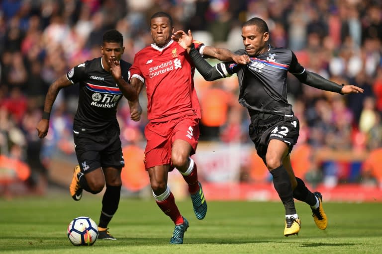 Liverpool's midfielder Georginio Wijnaldum (C) vies with Crystal Palace's midfielder Jason Puncheon (R) and Crystal Palace's defender Patrick van Aanholt (L) during the English Premier League football match August 19, 2017