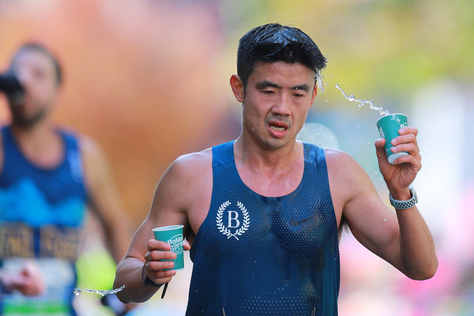 A runner grabs a cup of water during the 2019 New York City Marathon. (Photo: Gordon Donovan/Yahoo News)