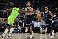 Memphis Grizzlies forward Kyle Anderson, center, passes the ball against Minnesota Timberwolves forward Anthony Edwards (1) in the second half of an NBA basketball game Monday, Nov. 8, 2021, in Memphis, Tenn. (AP Photo/Brandon Dill)