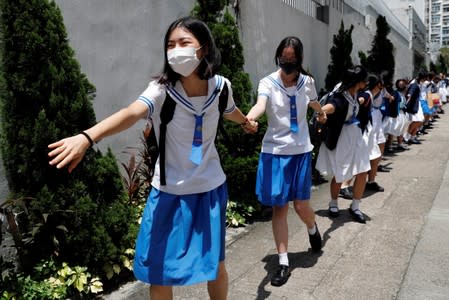 Secondary school students form a human chain against extradition bill in Hong Kong