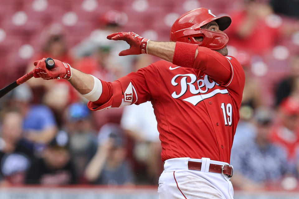 Cincinnati Reds' Joey Votto hits an RBI-single during the second inning of a baseball game against the Colorado Rockies in Cincinnati, Sunday, June 13, 2021. (AP Photo/Aaron Doster)