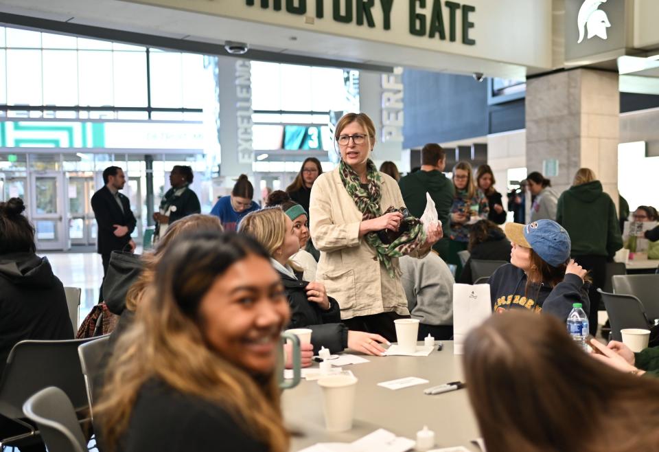 Michigan State University interim President Teresa Woodruff chats with students and other MSU community members on Monday, Feb. 12, 2024, during a luminary decorating event at the Breslin Center.