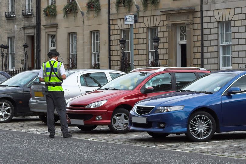 Traffic warden giving a ticket