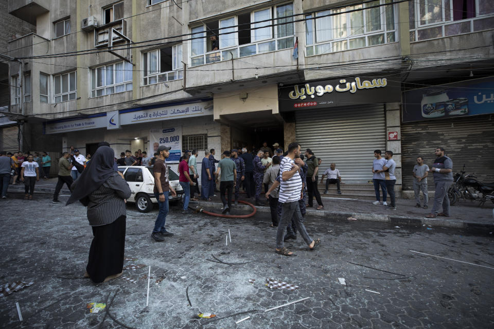 Palestinian Hamas security and residents gather next to the apartment of Taiseer al-Jabari the Islamic Jihad commander for northern Gaza, following an Israeli airstrike Friday, Aug. 5, 2022. Palestinian officials say Israeli airstrikes on Gaza have killed several people, including a senior militant, and wounded 40 others. (AP Photo/Fatima Shbair)