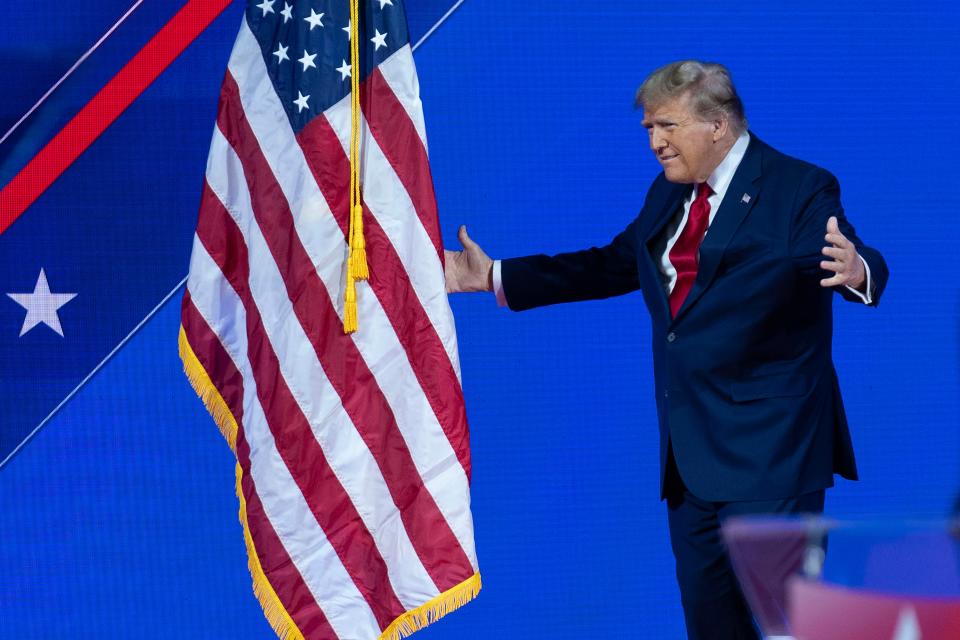 Republican presidential candidate former President Donald Trump walks to kiss the American flag before speaking during the Conservative Political Action Conference, CPAC 2024, at the National Harbor, in Oxon Hill, Md., on Feb. 24, 2024.