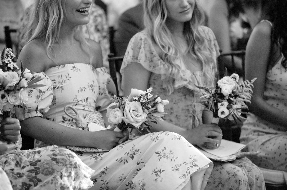 My beautiful bridesmaids wore romantic floral dresses with small bouquets of olive leaves, garden roses, lisianthus, and aster.