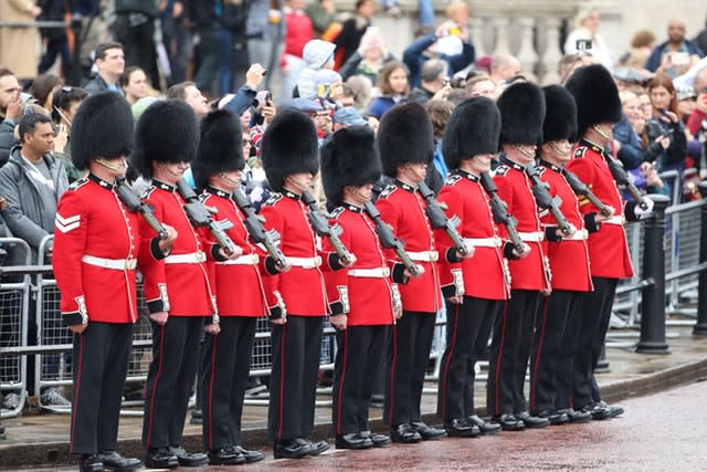 Soldiers from Nijmegen Company, Grenadier Guards, line the processional route on The Mall