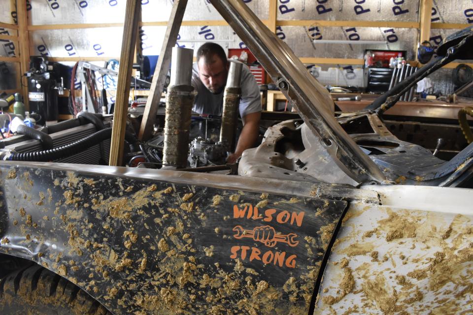 Matt Crane of Bloomington works on his demolition derby car on June 25. The Monroe County Fair's demolition derby is July 2.