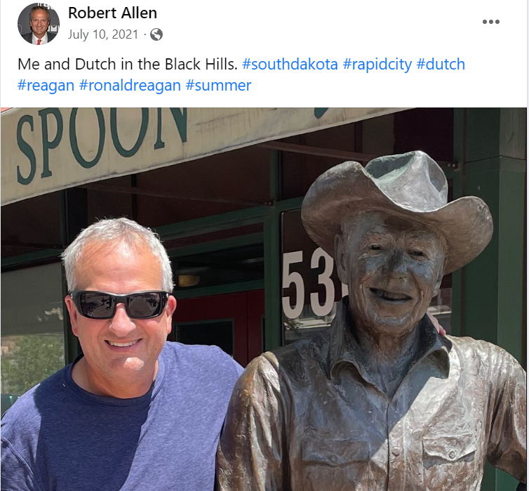 South Florida attorney Robert Allen poses with a statue of former Republican President Ronald Reagan in a photo posted on Allen's Facebook page.  Allen is a New College of Florida graduate who has told other alumni that he helped engineer Gov. Ron DeSantis' takeover of the Sarasota college. Allen's Facebook page is full of conservative commentary, and he used to frequently spar with New College alumni in a Facebook group before getting banned last week.