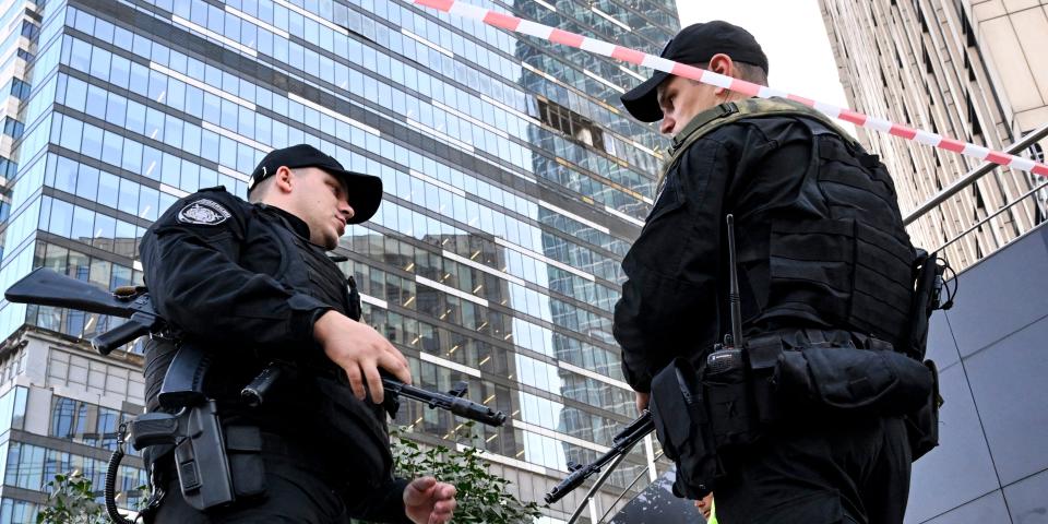 Police officers block off an area around a damaged office block of the Moscow International Business Center (Moskva City) following a reported drone attack in Moscow on August 1, 2023.