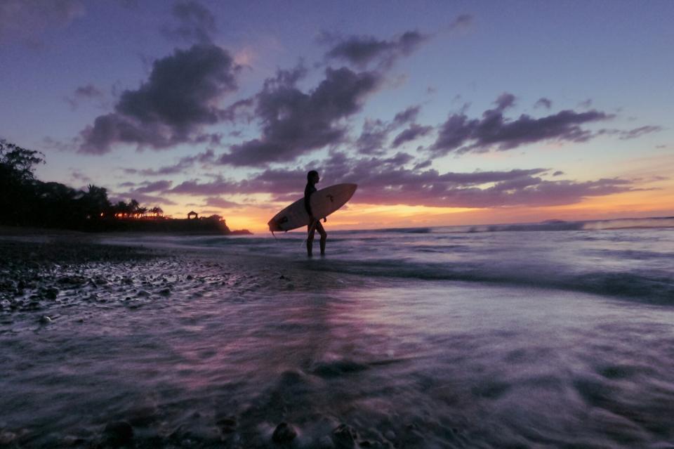 Silhouette of surfer at sunrise in Rincon, Puerto Rico