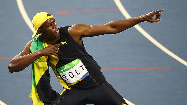 Usain Bolt ran into the Olympic record books after becoming the first person in history to win three straight 100m titles.