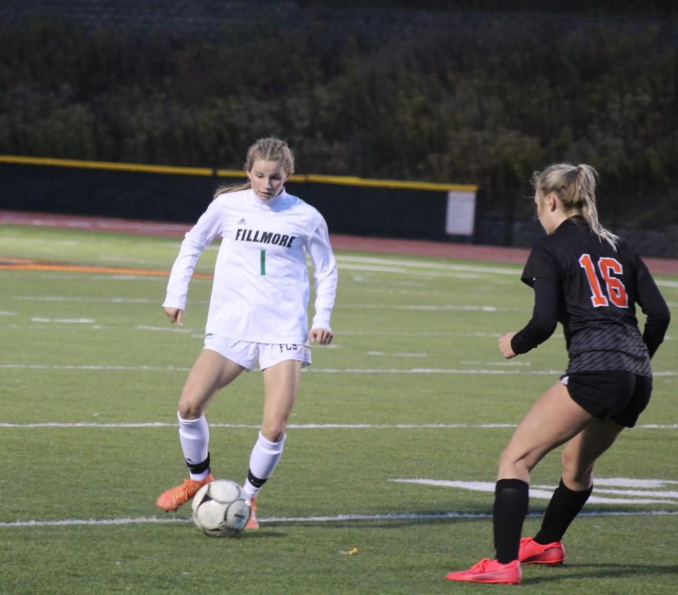 Fillmore's Sophia Templeton (1) looks to maneuver around Wellsville's Marley Adams Thursday night.