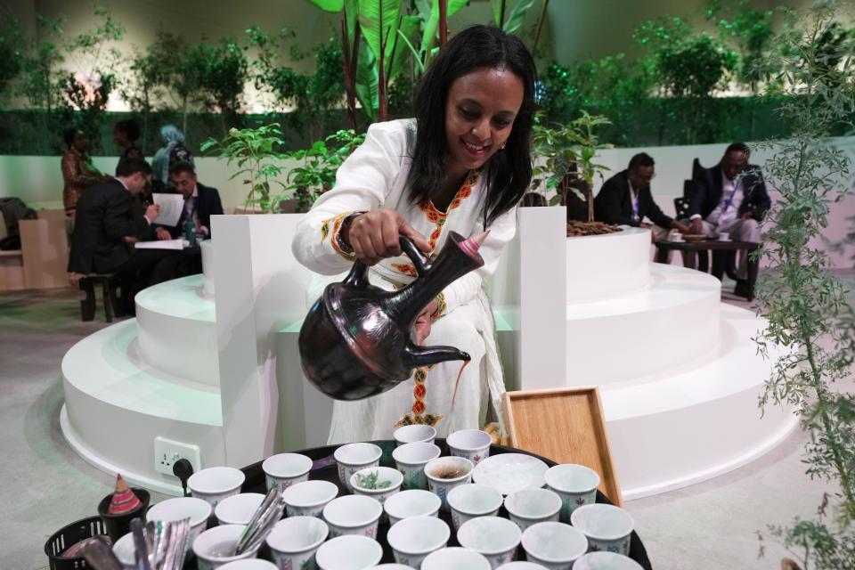 Fatuma alemu Ahmed pours coffee from Ethiopia at the COP28 U.N. Climate Summit, Saturday, Dec. 2, 2023, in Dubai, United Arab Emirates. (AP Photo/Peter Dejong)