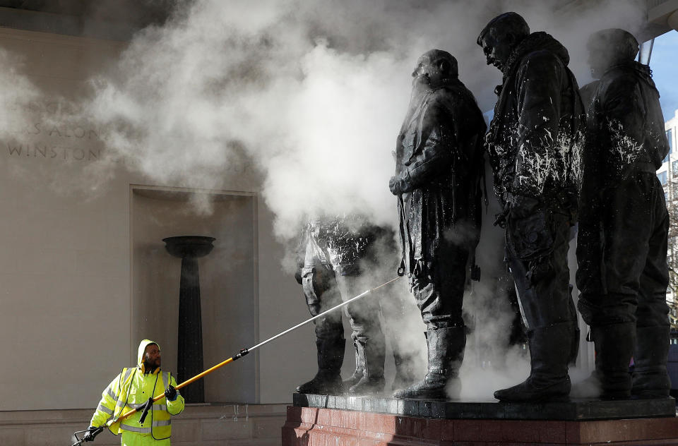 A worker cleans the paint defaced Bomber Command Memorial in Green Park, London, Britain January 22, 2019.