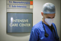 A medical staffer looks down as he walks outside the intensive care unit of the Circolo Hospital and Macchi Foundation of Varese, Italy, Friday, Oct. 30, 2020. Italy on Friday added more than 31,000 confirmed new cases of COVID-19 since the previous day, the highest one-day new caseload for the country in the pandemic. “The epidemic is galloping” in Italy, said Gianni Rezza, a top Health Ministry official. (Claudio Furlan/LaPresse via AP)