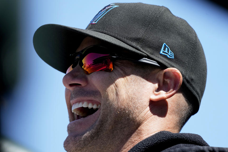 Miami Marlins manager Skip Schumaker laughs as he looks to the field before a baseball game against the Chicago Cubs in Chicago, Sunday, April 21, 2024. (AP Photo/Nam Y. Huh)