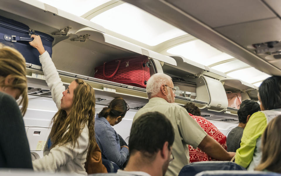 On busy flights hand luggage is often placed in the hold - Credit: GETTY
