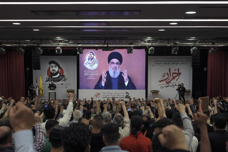File - Supporters of the Iranian-backed Hezbollah group listen to a speech by Hezbollah leader Sayyed Hassan Nasrallah speaking via a video link, in the southern suburbs of Beirut, Lebanon, Tuesday, May 14, 2024. Israel and the Lebanese militant group Hezbollah have recently ratcheted up their threats of an all-out war. Hezbollah leader Hassan Nasrallah warned Israel last week that if it launches an offensive in Lebanon, his group has new weapons and capabilities it can use against Israeli forces and cities, unlike during their previous wars. (AP Photo/Hassan Ammar, File)