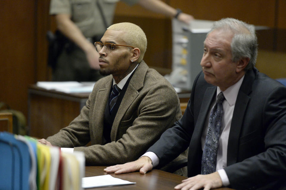 R&B singer Chris Brown, left, appears in court with his attorney Mark Geragos during a probation violation hearing in which his probation was revoked by a Los Angeles Superior judge on Monday, Dec. 16, 2013, in Los Angeles. Superior Court Judge James R. Brandlin revoked Brown's probation after his recent arrest on suspicion of misdemeanor assault in Washington, D.C., but the ruling will not alter the singer's requirements to complete rehab and community labor for his 2009 attack on Rihanna. (AP Photo/Kevork Djansezian, Pool)