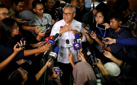 The head of the Indonesian election commission briefs local media on the results - Credit: Willy Kurniawan/Reuters