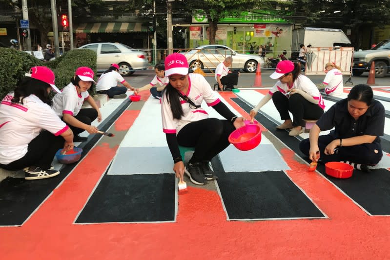 People paint a 3D pedestrian crossing in Bangkok