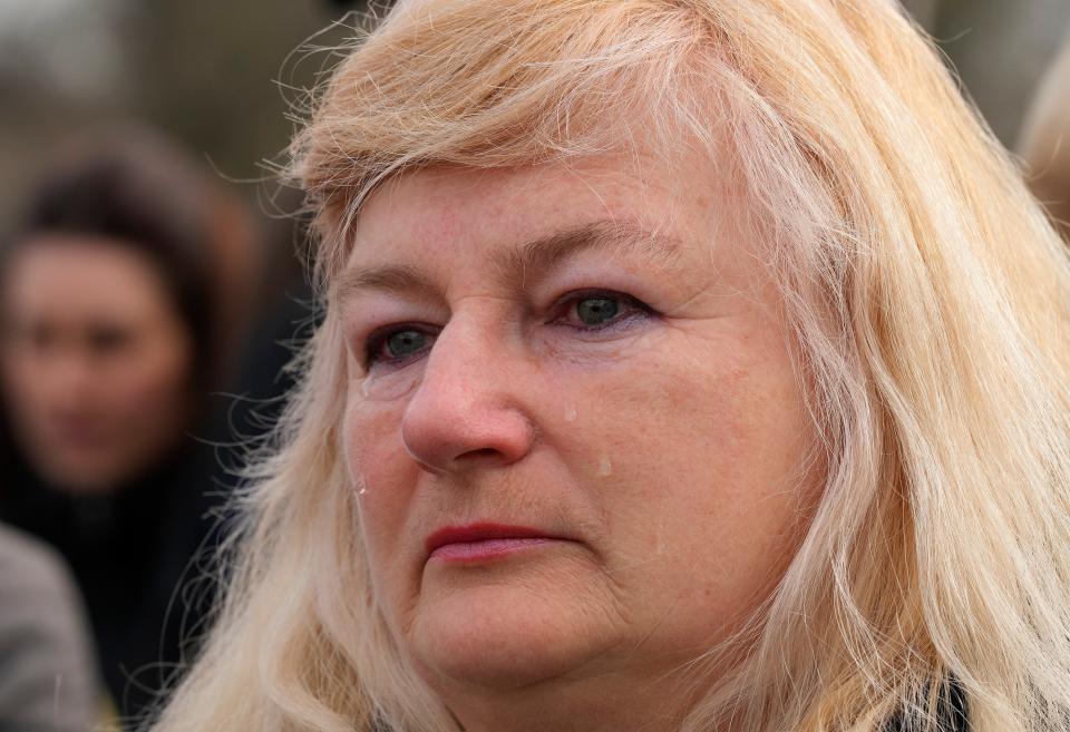 A woman cries during the singing of the national anthem during a visit by Ukrainian President Volodymyr Zelensky (Copyright 2023 The Associated Press. All rights reserved)