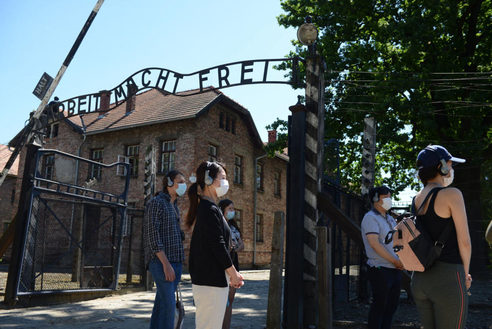 Visitors are seen near the gate of German Nazi death camp Auschwitz in Oswiecim. Source: Getty Images