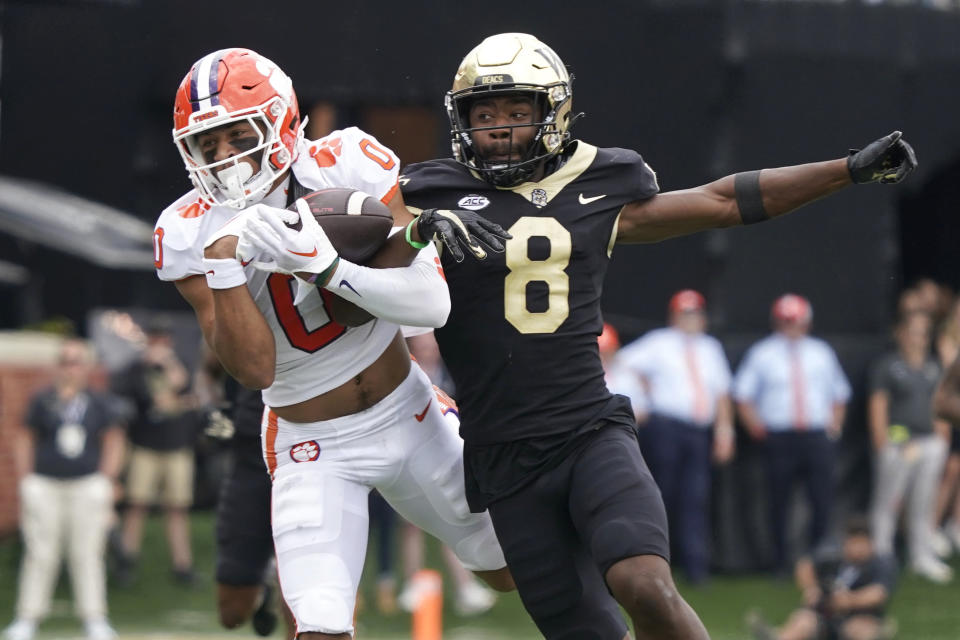 Clemson wide receiver Antonio Williams (0) catches a pass against Wake Forest defensive back Isaiah Wingfield (8) during the first half of an NCAA college football game in Winston-Salem, N.C., Saturday, Sept. 24, 2022. (AP Photo/Chuck Burton)