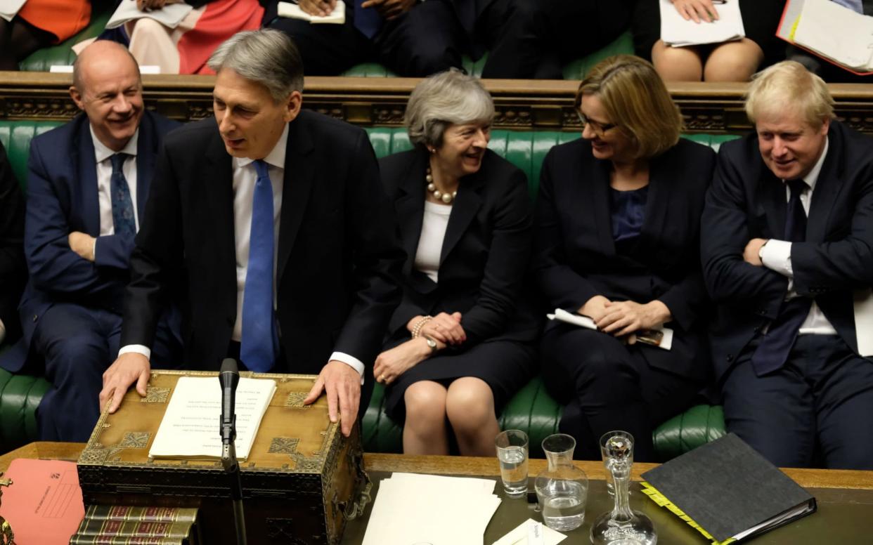 Philip Hammond said a typical basic rate tax payer would be £1,075 a year better off as a result of the moves - PA