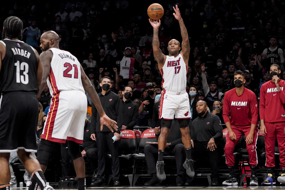 Miami Heat forward P.J. Tucker shoots for three points during the first half of an NBA basketball game against the Brooklyn Nets, Wednesday, Oct. 27, 2021, in New York. (AP Photo/John Minchillo)