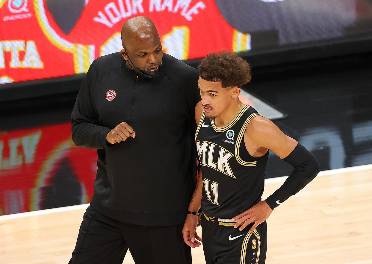 Head coach Nate McMillan of the Atlanta Hawks converses with Trae Young