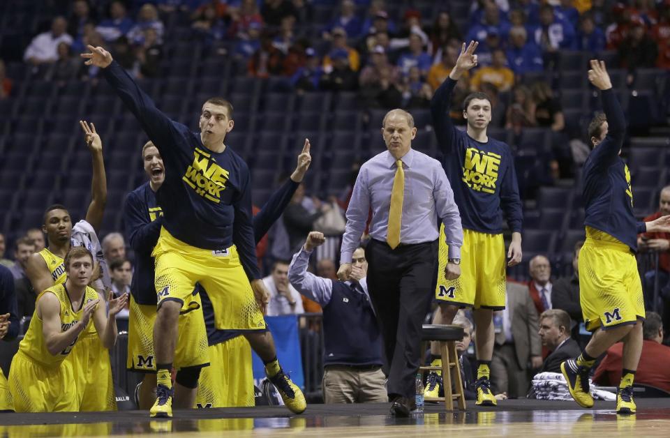 The Michigan bench reacts during the first half of an NCAA Midwest Regional semifinal college basketball tournament game against the Tennessee Friday, March 28, 2014, in Indianapolis. (AP Photo/David J. Phillip)