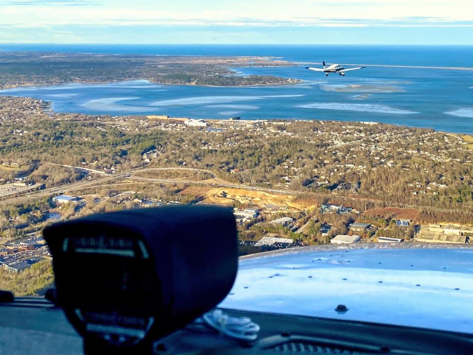 The South Shore Flying Club’s Piper Archer leads its mate, a Cessna 172 Skyhawk, in a flying formation.