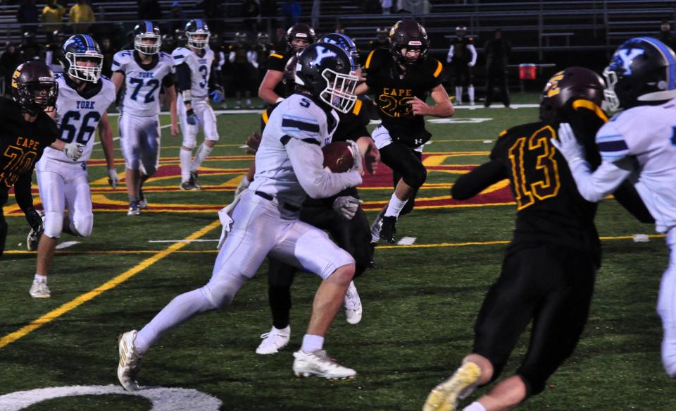 York’s Brody Gullison, center, breaks loose for a 53-yard TD run during Monday night’s Class B South playoff game in Cape Elizabeth, Maine