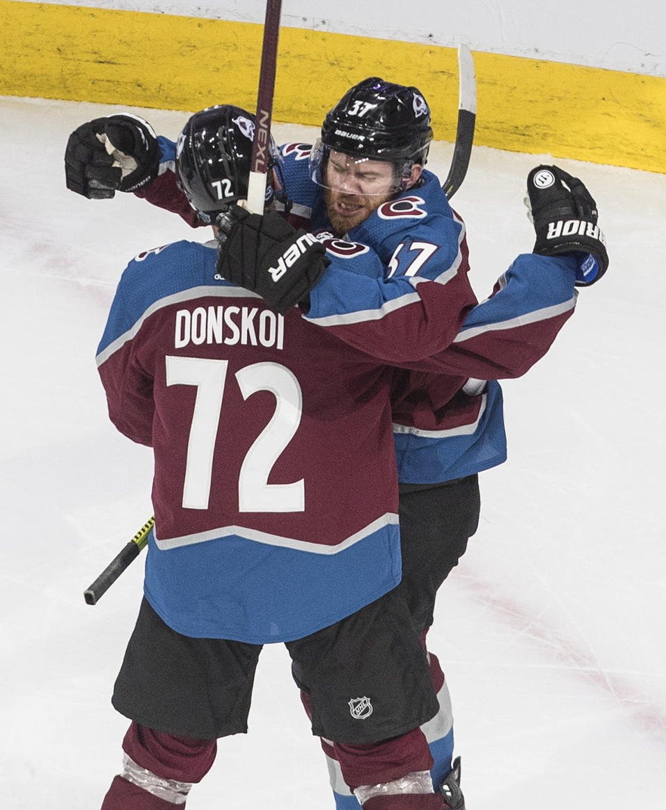 Colorado Avalanche's Joonas Donskoi (72) and J.T. Compher (37) celebrate a goal against the Arizona Coyotes during the third period of a first-round NHL Stanley Cup playoff hockey game in Edmonton, on Wednesday, Aug. 12, 2020. (Jason Franson/The Canadian Press via AP)