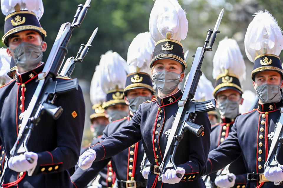 Belgium's Crown Princess Elisabeth, center, marches past the Royal tribune with cadets of the military school during the National Day parade in Brussels, Wednesday, July 21, 2021. Belgium celebrates its National Day on Wednesday in a scaled down version due to coronavirus, COVID-19 measures. (Laurie Dieffembacq, Pool Photo via AP)