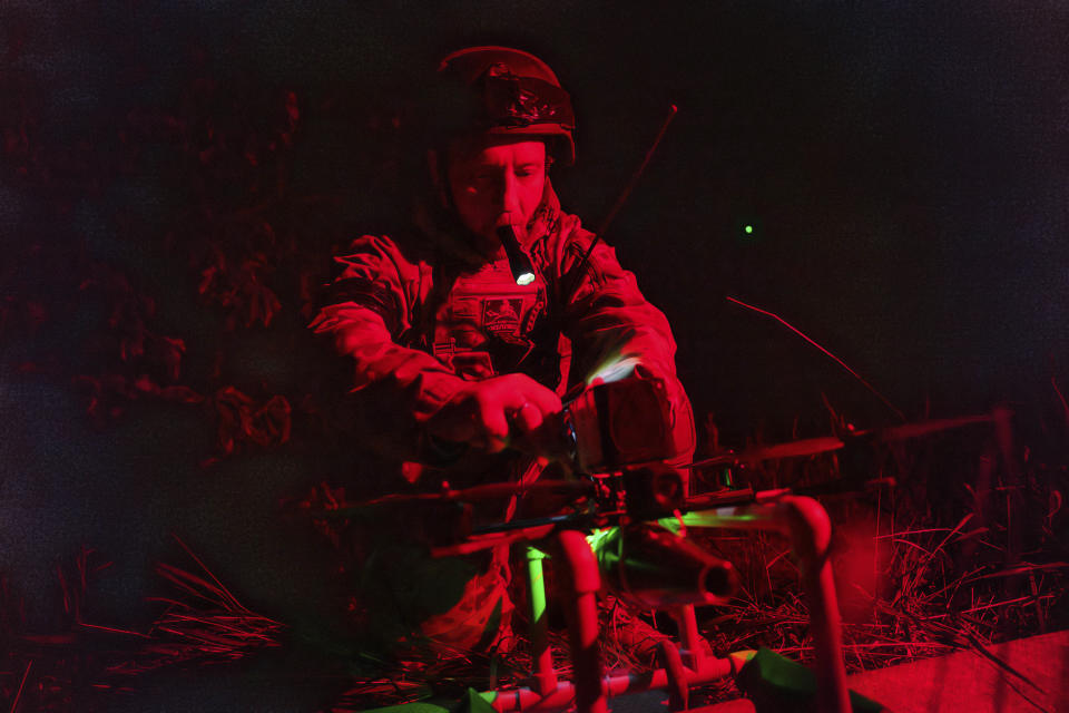 A Ukrainian serviceman of the ACHILLES battalion of the 92nd brigade turns on a suicide drone in the take-off position before its flight over Russian positions in the Kharkiv region of Ukraine on Monday, May 13, 2024. (AP Photo/Evgeniy Maloletka)