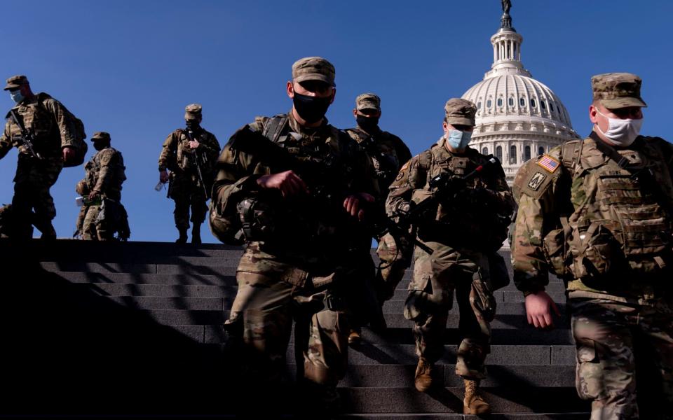 Members of the National Guard walk past the Dome of the Capitol Building on Capitol Hill  - Andrew Harnik /AP Pool 