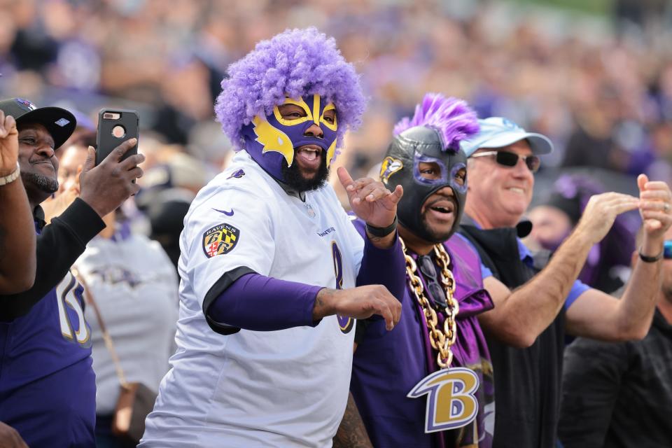 Oct 17, 2021; Baltimore, Maryland, USA; A Baltimore Ravens fans celebrate a Ravens touchdown during the first half against the Los Angeles Chargers at M&T Bank Stadium. Mandatory Credit: Vincent Carchietta-USA TODAY Sports