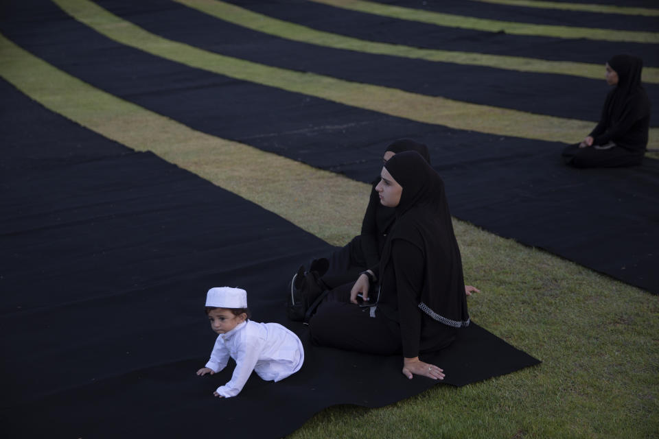 Muslim worshippers gather for Eid al-Adha prayer in the mixed Arab Jewish city of Jaffa, near Tel Aviv, Israel, Tuesday, July 20, 2021. The major Muslim holiday, at the end of the hajj pilgrimage to Mecca, is observed around the world by believers and commemorates prophet Abraham's pledge to sacrifice his son as an act of obedience to God. (AP Photo/Oded Balilty)